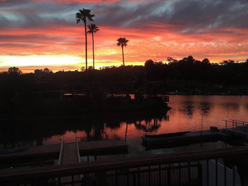 Sunset sky reflecting over calm waterfront