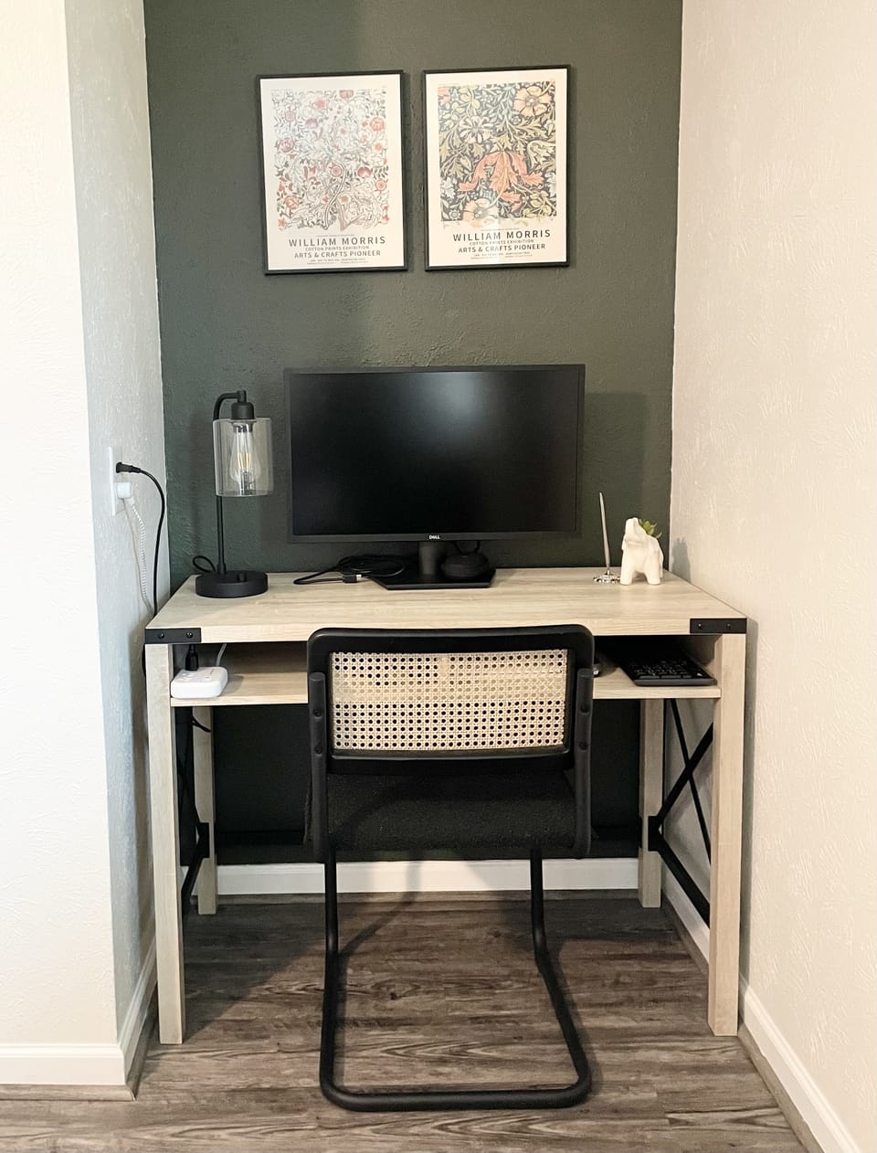 Work nook with charging outlets, a monitor, and a wireless keyboard & mouse.
