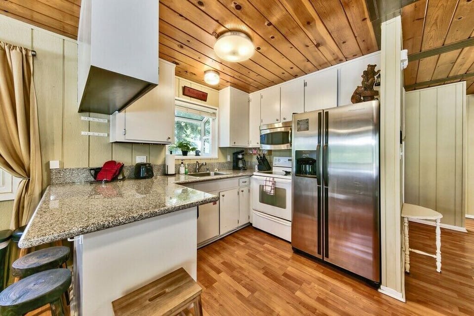 The cozy living room is an ideal space for relaxing after a long day of exploring South Tahoe. This room is equipped with a gas fireplace, comfy couches, and a large flat screen TV.
