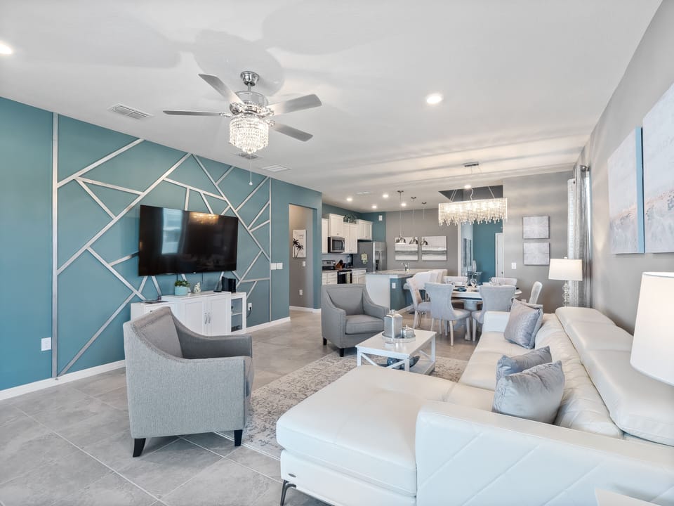 Spacious Downstairs Living Area with Comfortable Seating and Flat Screen TV