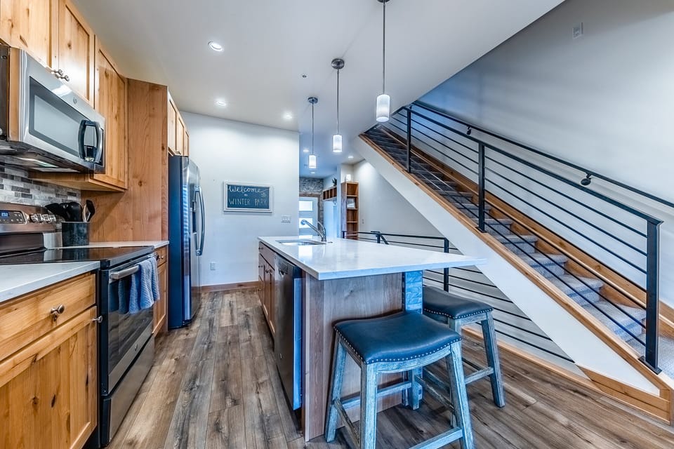 Kitchen - Stainless steel appliances, pendant lighting, and kitchen accessories galore.