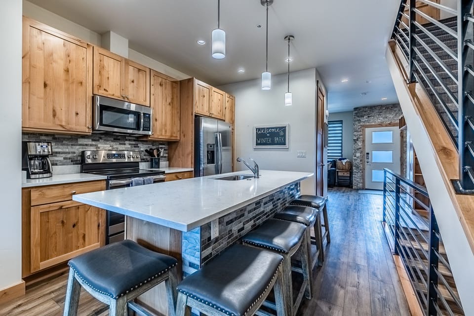 Kitchen - Large granite top kitchen island with seating for 5.