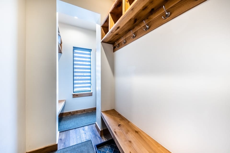 Entrance - Coat hooks and bench located in the lower level entry way off the garage.
