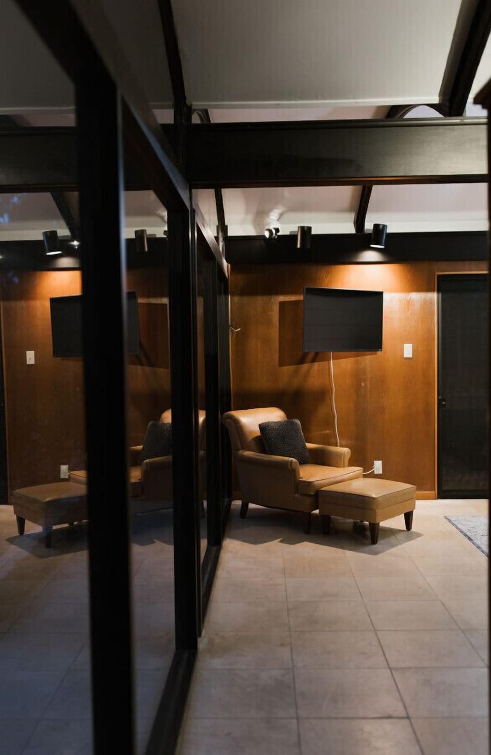 The large master bedroom has a smart-tv and a super comfy reading chair.