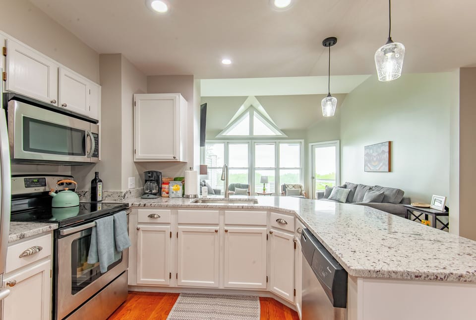 The kitchen opens directly to the living room with beautiful views.