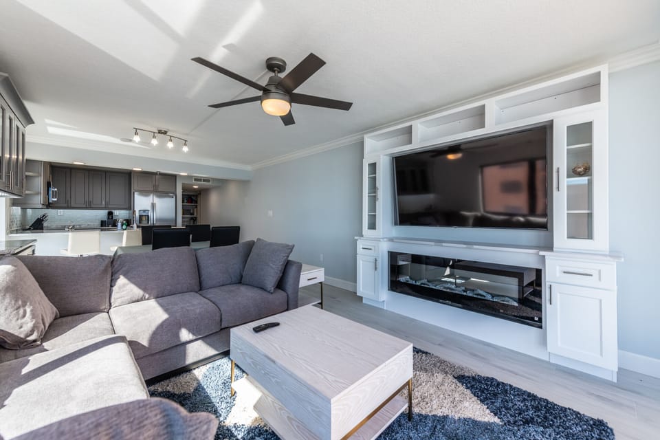 Modern built-in entertainment center with a large TV and stylish shelving.