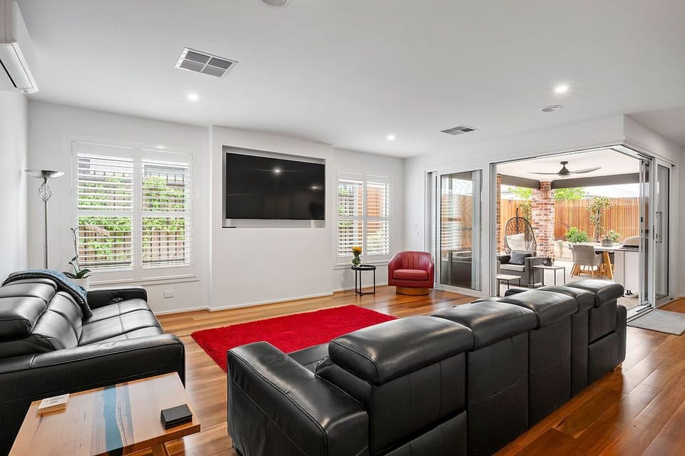 Large TV and recliner couches in main living area 