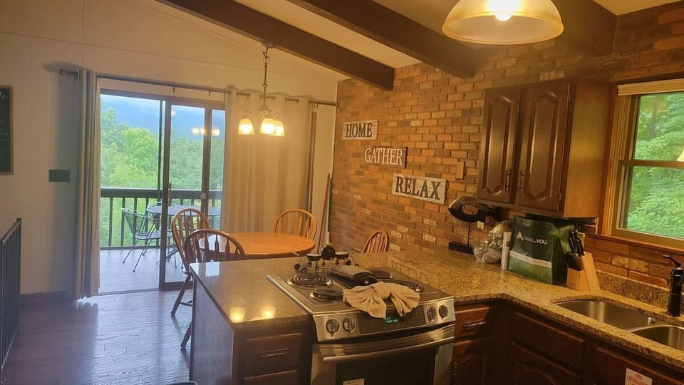Kitchen looking into dining area and out over back deck.
