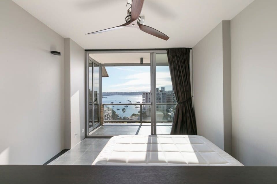 Queen bed in master bedroom with balcony views