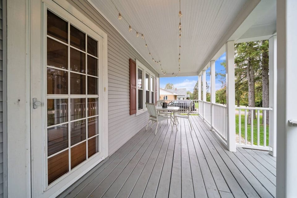 The front porch spans the width of the home. There is a dining set that seats 4, and a very spacious side yard for games.
