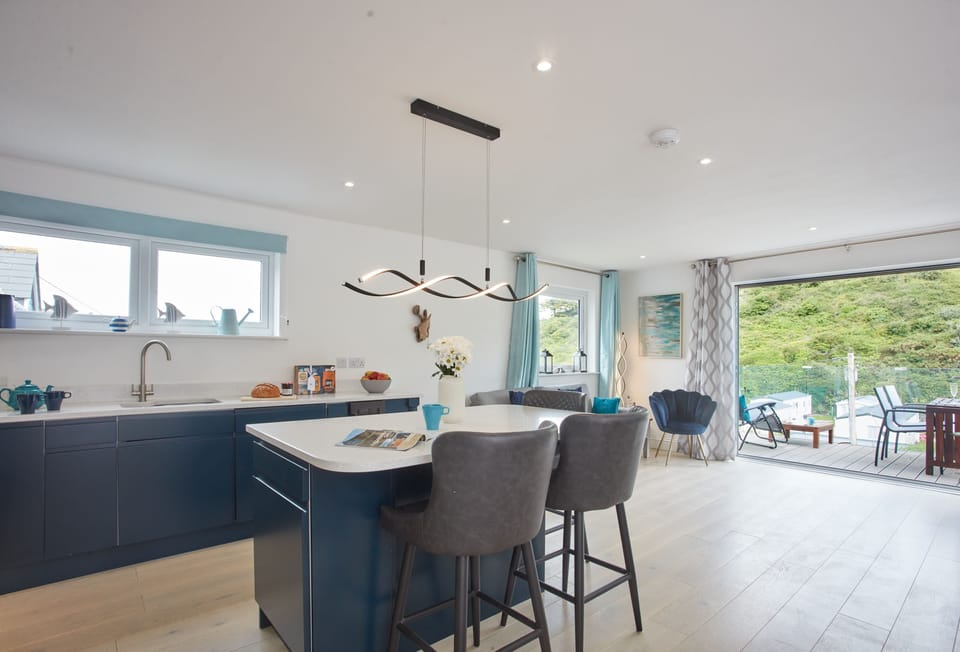Anneth Lowen, Polzeath. Well equipped kitchen area with contemporary units, American Fridge/freezer, electric oven and ceramic hob, microwave and dishwasher