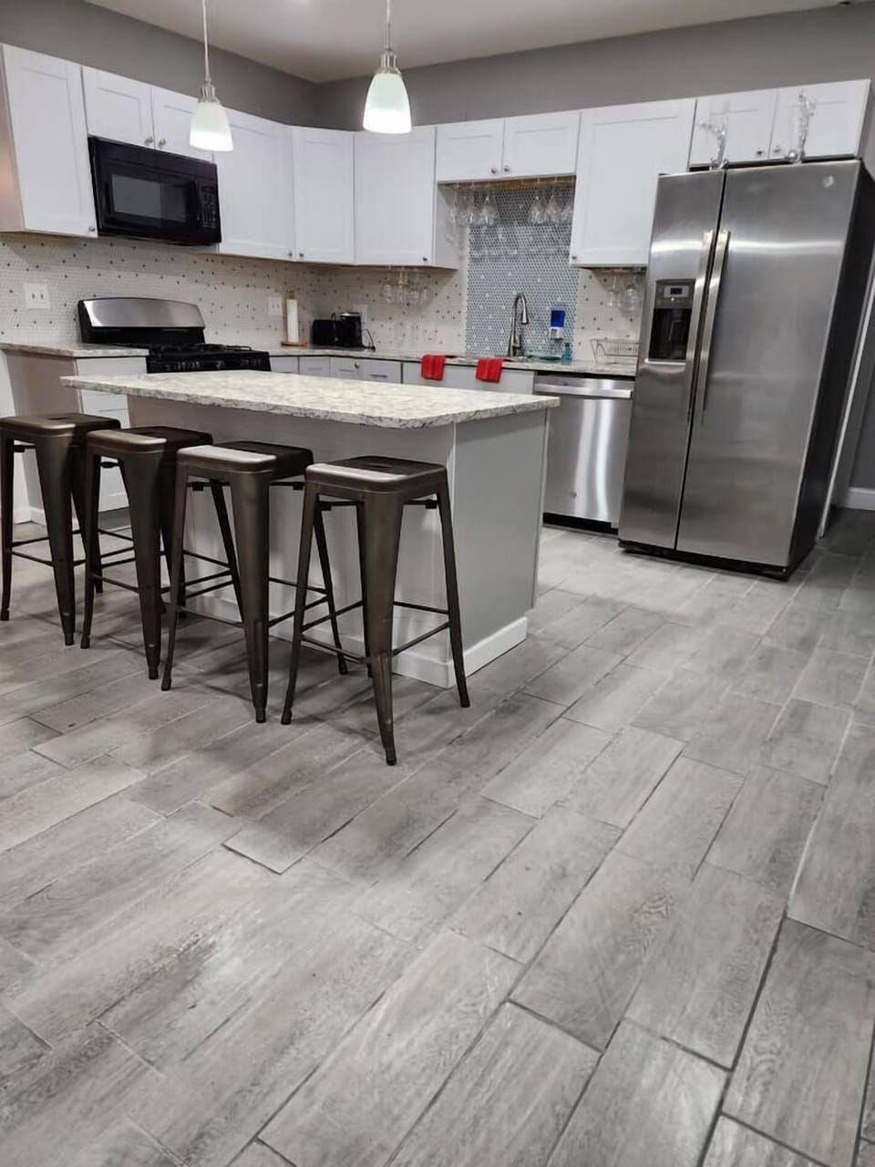 Lovely spacious kitchen to cook and enjoy your meals; Large island to sit and eat; Brand new stainless steel appliances. 