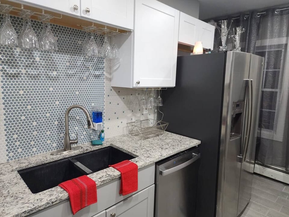 Double basin kitchen sink, dishwasher, and dish drainer are available.