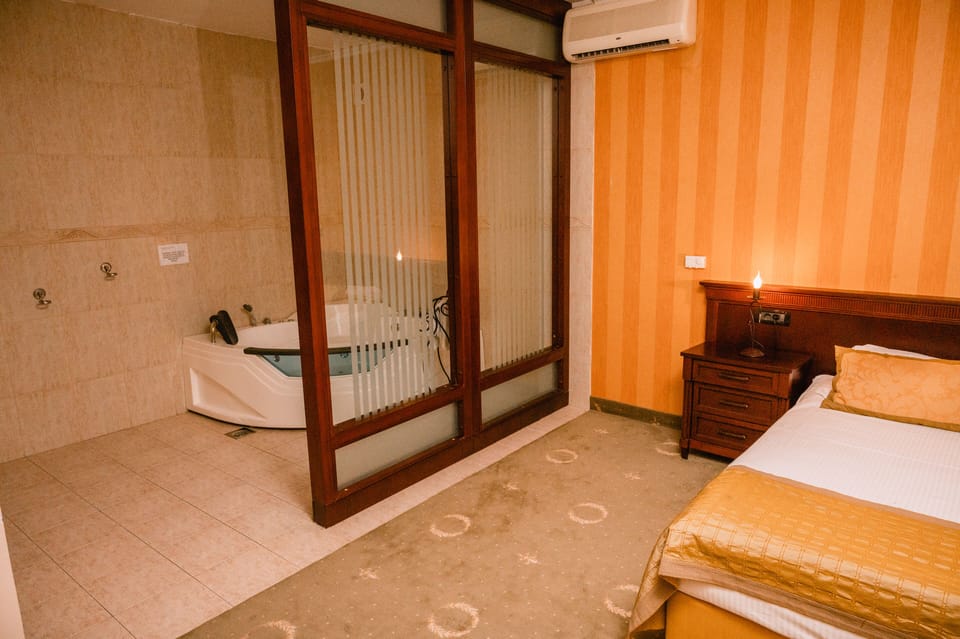 Luxury Suite, 1 King Bed | Bathroom | Shower, hair dryer, bathrobes, slippers