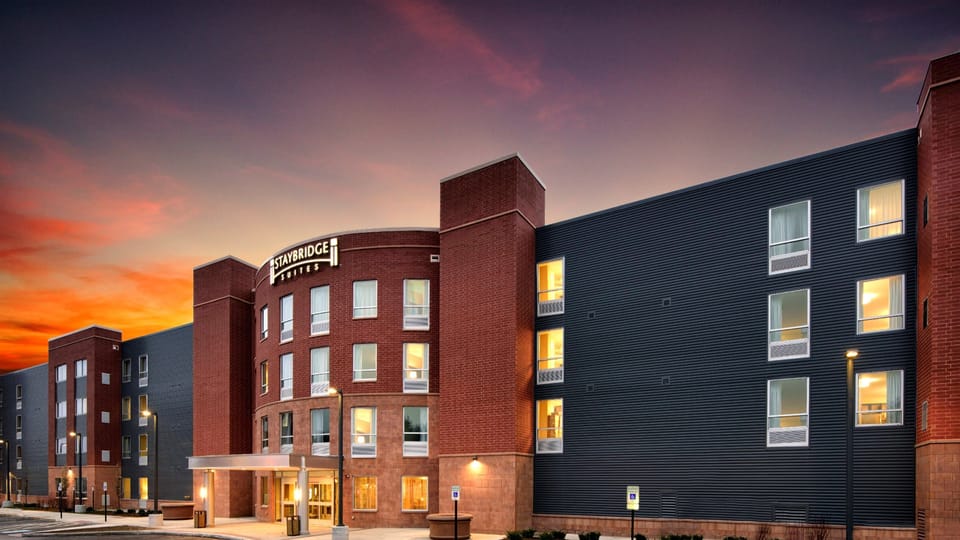 Modern property exterior with parking area at dusk.