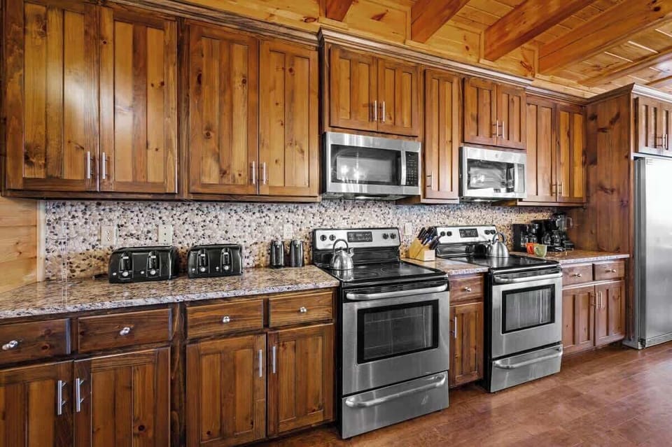 Kitchen has everything you need including two stoves, two dishwashers, and huge industrial size refrigerator