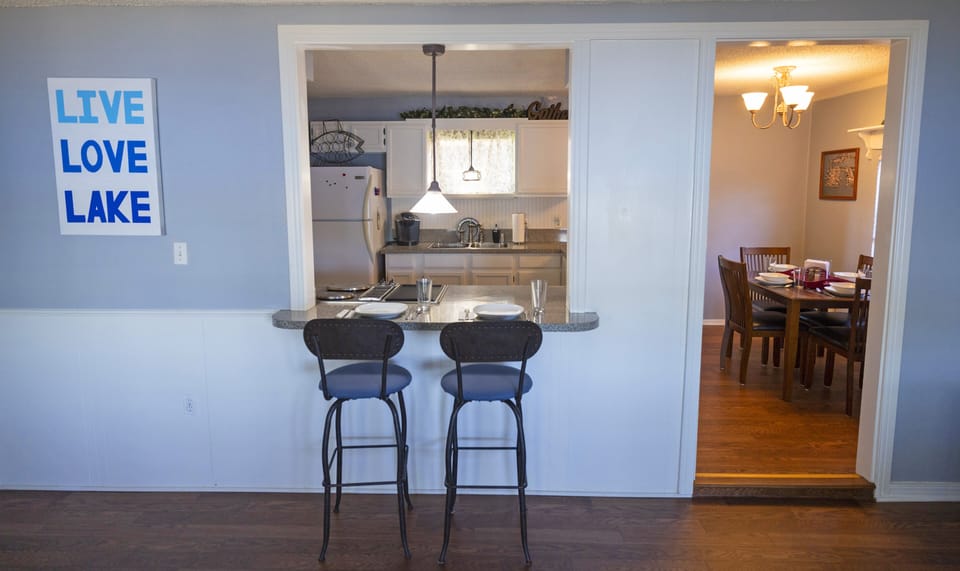 There are two barstools at the eat-in kitchen bar.