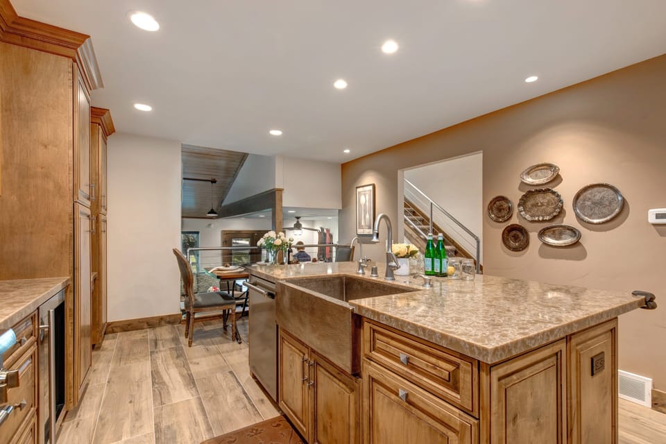 Fully Equipped Kitchen with beautiful stone countertops, hardwood floor, stainless steel Thermadore appliances, (including 3 ovens), ice maker, and island seating for three