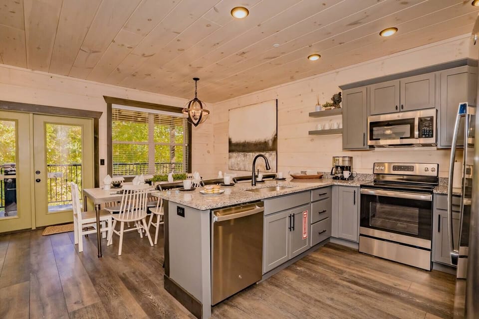 Kitchen: Modern design meets nature with scenic views and stylish dining for unforgettable meals!