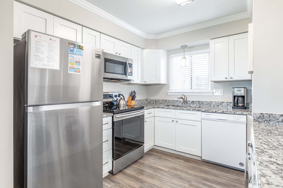 Bright fully equipped kitchen with all stainless appliances