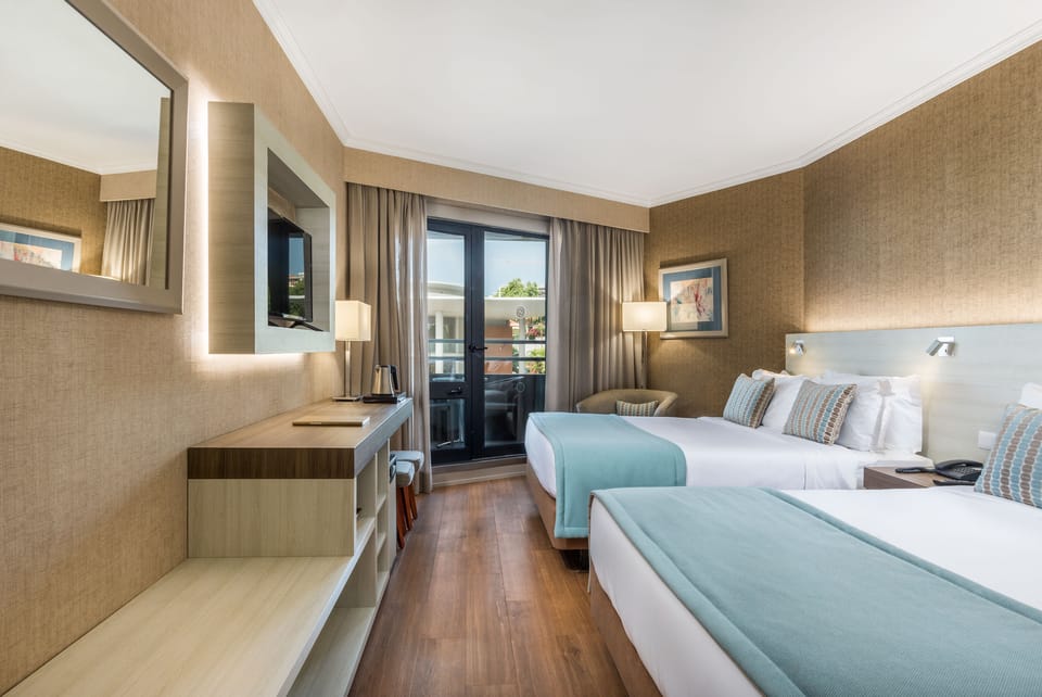 Family Room | Free minibar, in-room safe, desk, blackout drapes