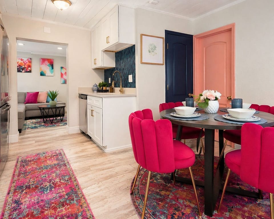 Bright dining area with vibrant seating and seamless flow to kitchen and living.