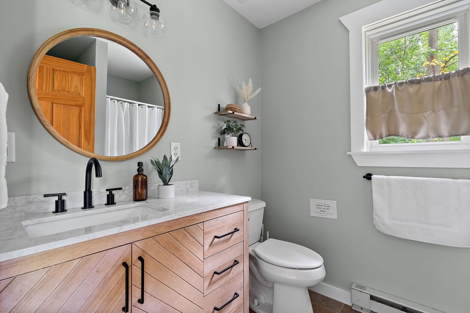 Newly remodeled bathroom equipped with shampoo, conditioner, body wash, towels)