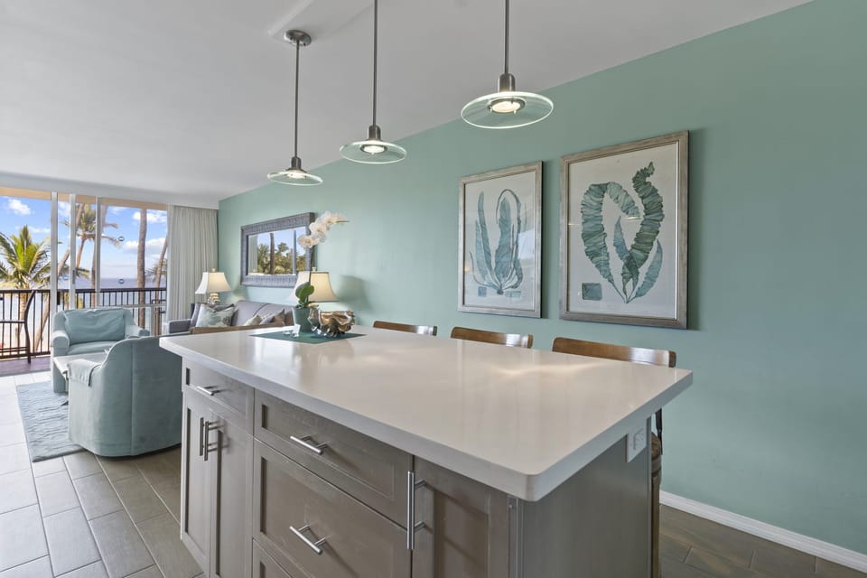 Kitchen Island seats four, quality surfaces and cabinetry.