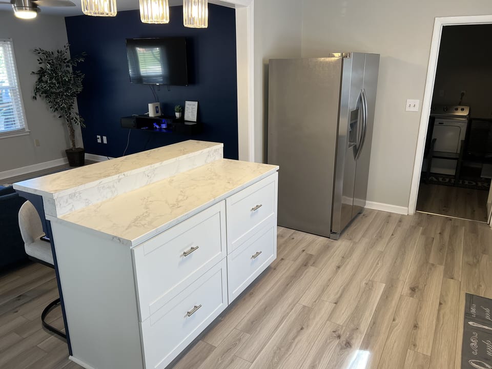 Ample counter space is available including  a marble island w/ high top seating