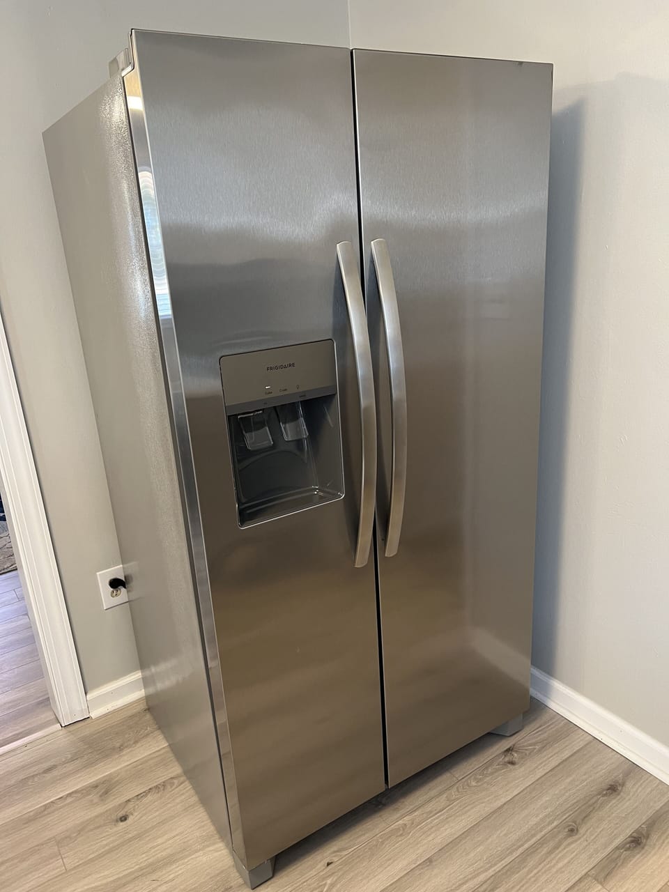 Modern appliances including a stainless steel refrigerator with filtered water