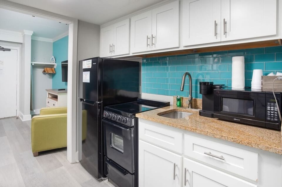 A kitchenette sits between the two rooms.