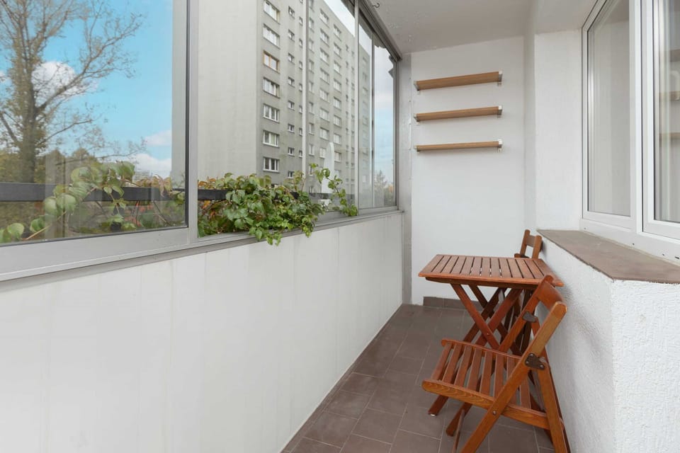 A private balcony with seating arrangements, perfect for enjoying coffee or relaxing while taking in the surroundings.

