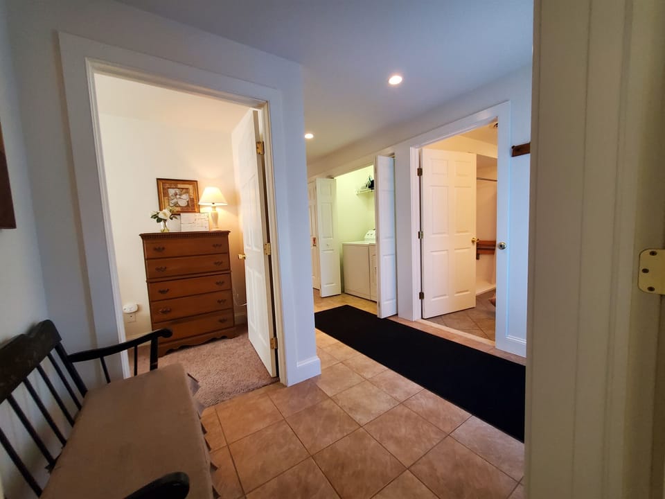 View of main hallway and the entrance into the handicap accessible bathroom and the laundry area.
