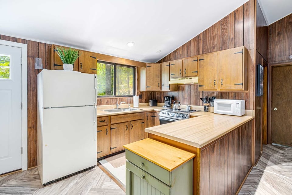 Fully-stocked kitchen with a stove/oven, and microwave