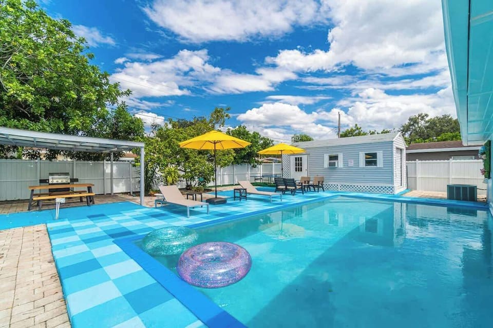 Relax by the sparkling pool with comfy loungers and sunny umbrellas—your perfect vacation rental escape awaits!