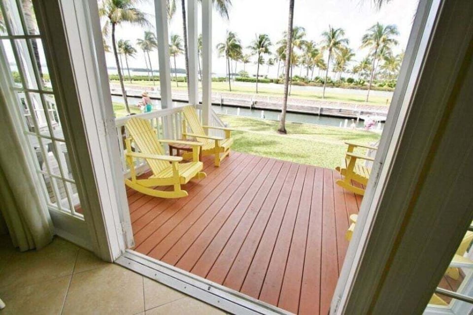 Relaxing porch space adorned with comfortable seating for unwinding outdoors.