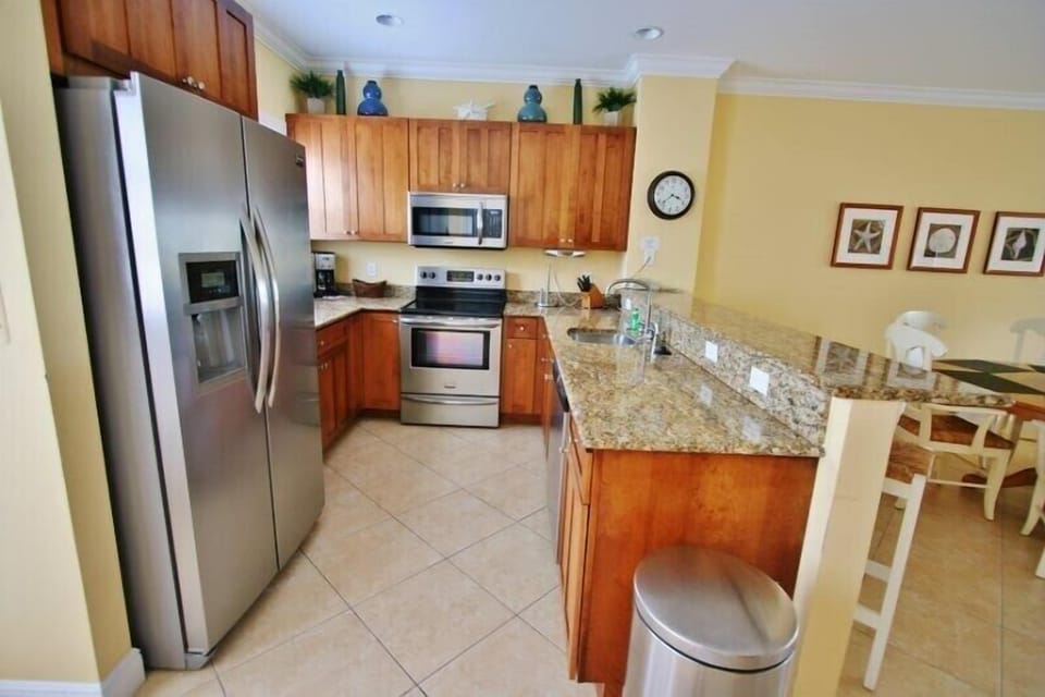 Fully equipped kitchen with stylish bar stools, perfect for casual dining and entertaining.
