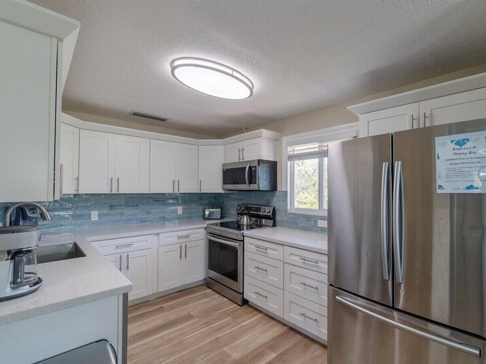Prepare meals with ease in this spacious kitchen stocked with all the essentials.