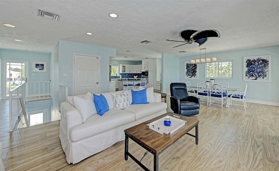Open-concept design seamlessly connects living, dining, and kitchen spaces.