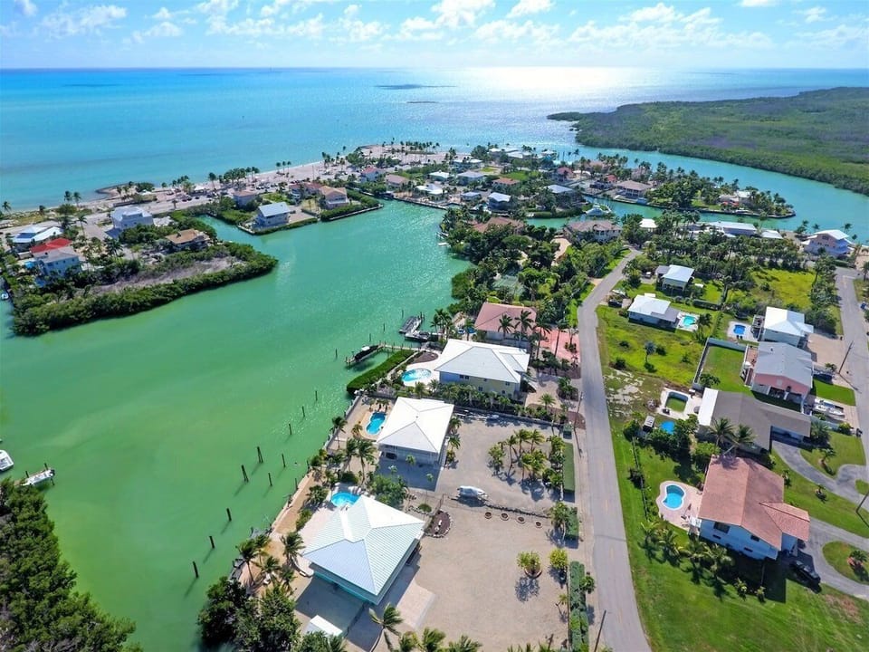 Aerial view showcasing the home's exceptional waterfront setting with quick access to open water.