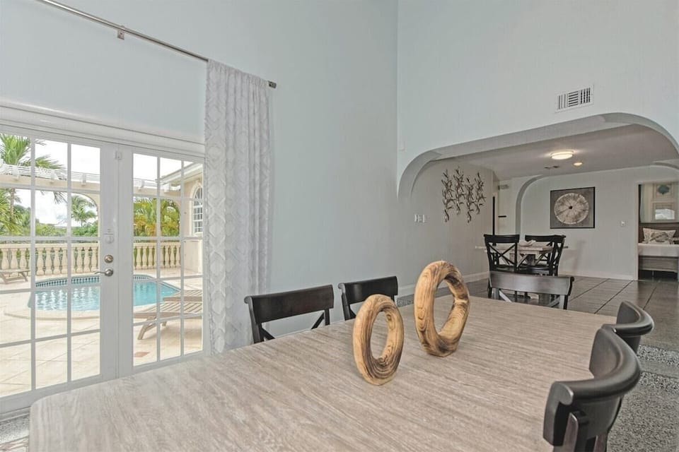 Entertainment meets elegance in this expansive area featuring a 6-seater dining space, a cozy living room, and an additional 4-seater table perfect for games or intimate dining.