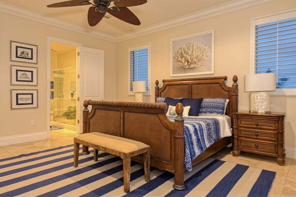 Private master suite offering comfort and tranquility in a waterfront setting.