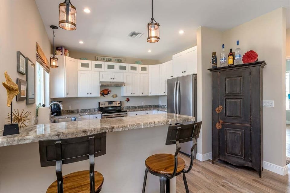 Granite countertops, modern appliances, and open sightlines make every meal a memorable occasion.