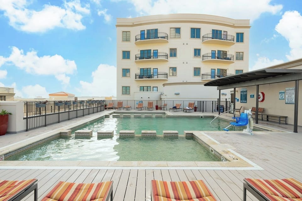 Rooftop Pool • Lounge Chairs in Foreground