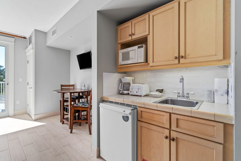 Kitchenette with dishwasher and cooking essentials