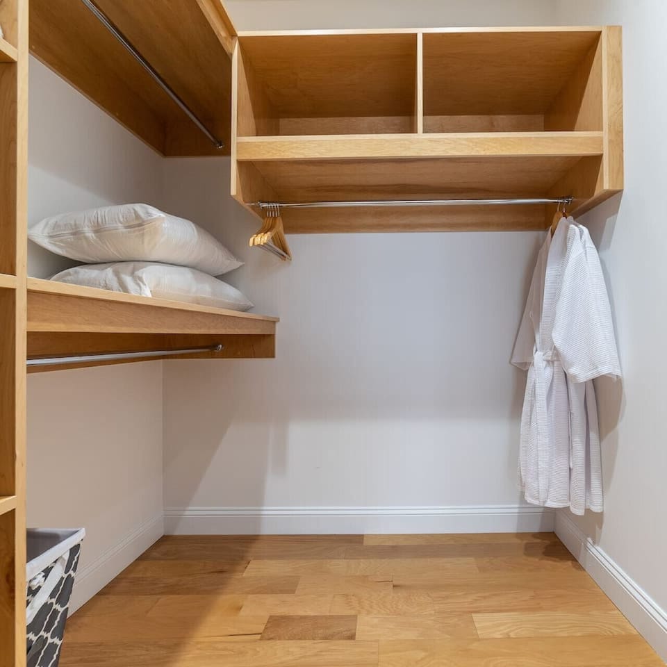 Convenient storage room equipped with hangers and a bonus pillow for added comfort.