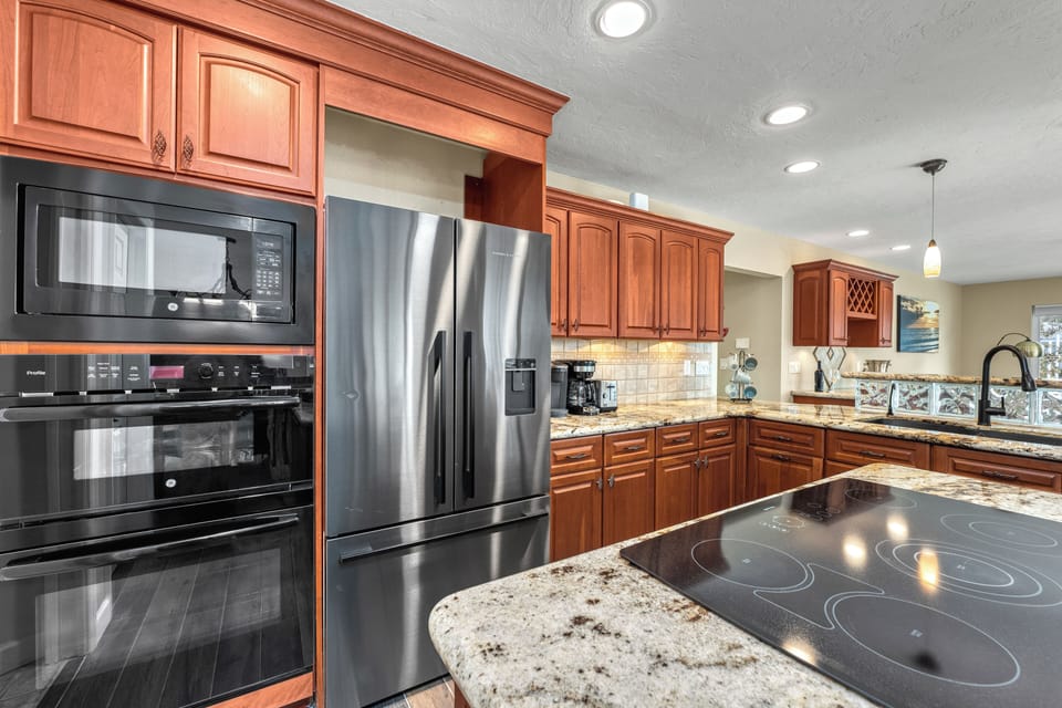 The modern electric range and spacious counters make cooking simple, efficient, and enjoyable for any meal.
