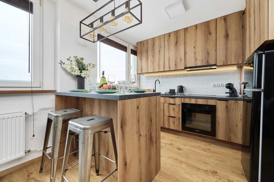 A wooden kitchen island with bar stools, perfect for casual dining or enjoying a drink.
