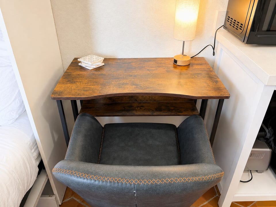 Get some focused work done at this laptop friendly workstation complete with a touch activated lamp that has an outlet for charging devices at night or powering your laptop during the day.
