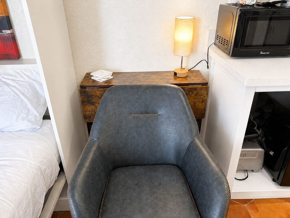 Fold down the desk in half to open up space and watch some TV (mounted on the opposite wall).